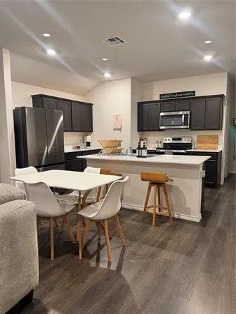 a kitchen with a table and chairs in it
