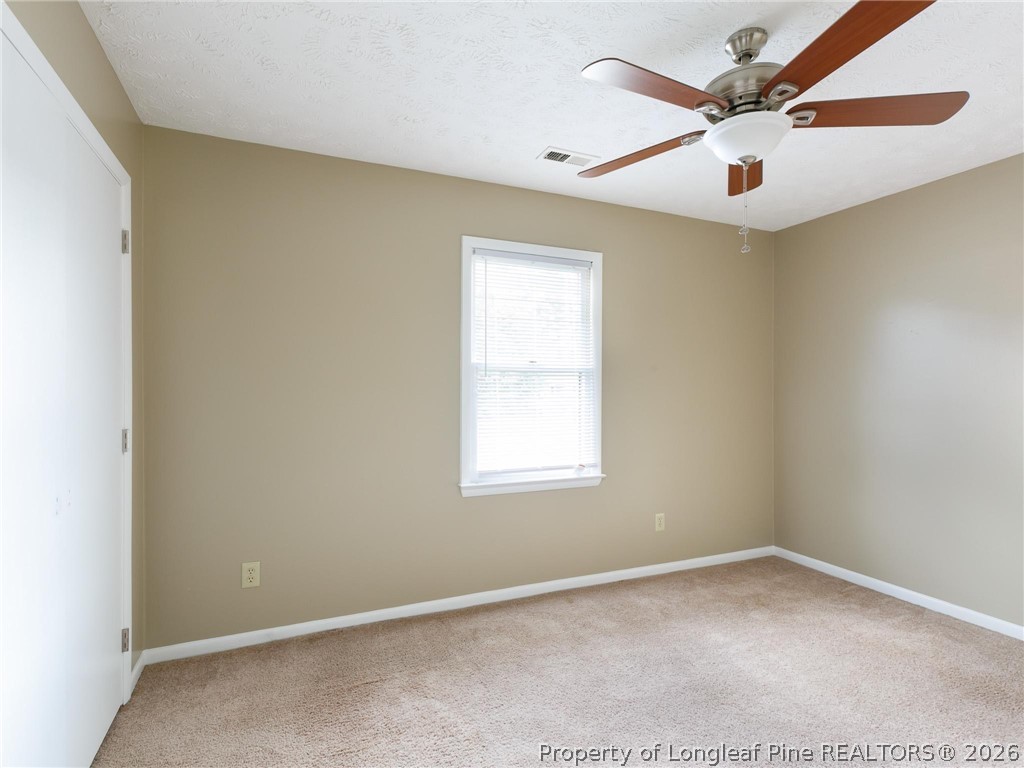 115 Eulon Loop, Unit A Raeford, NC 28376 - Photo 6 of 16 an empty room with a window and a fan