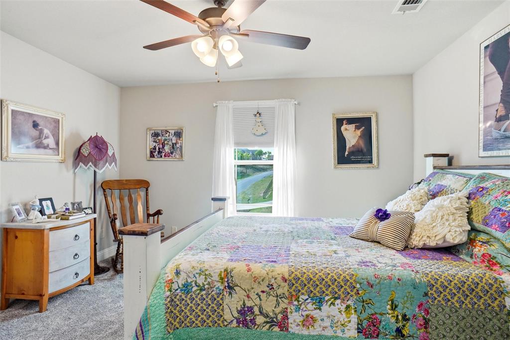 1024 Tex Lane Springtown, TX 76082 - Photo 31 of 40 a bedroom with a bed and a chandelier