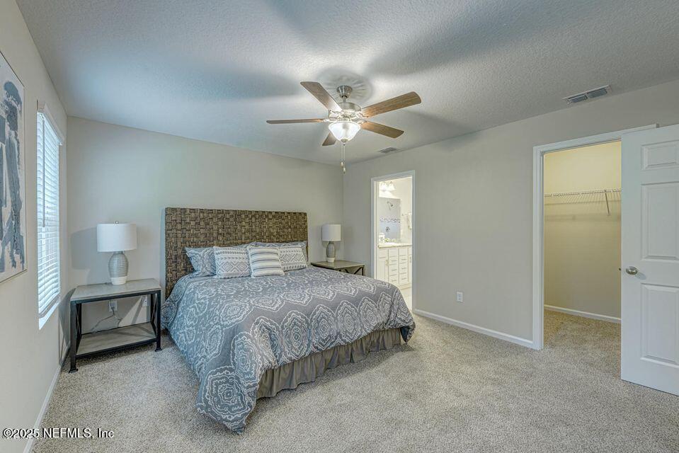 8822 Orme Road Jacksonville, FL 32220 - Photo 12 of 26 a bedroom with a bed and a ceiling fan
