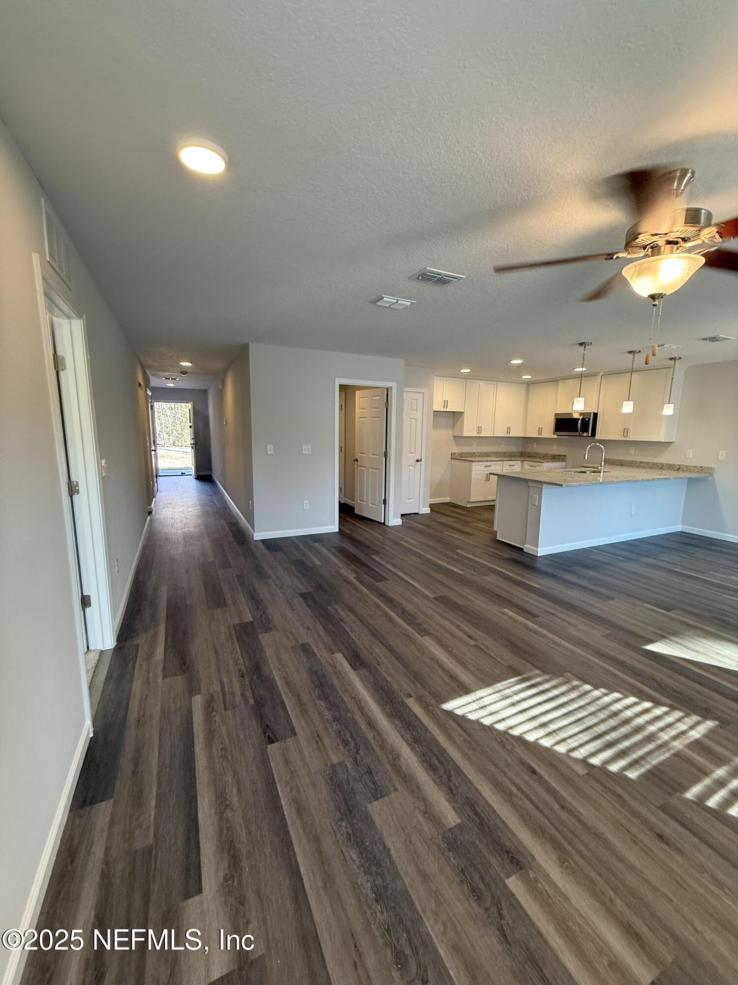 8822 Orme Road Jacksonville, FL 32220 - Photo 20 of 26 a view of a living room a rug floor and a ceiling fan