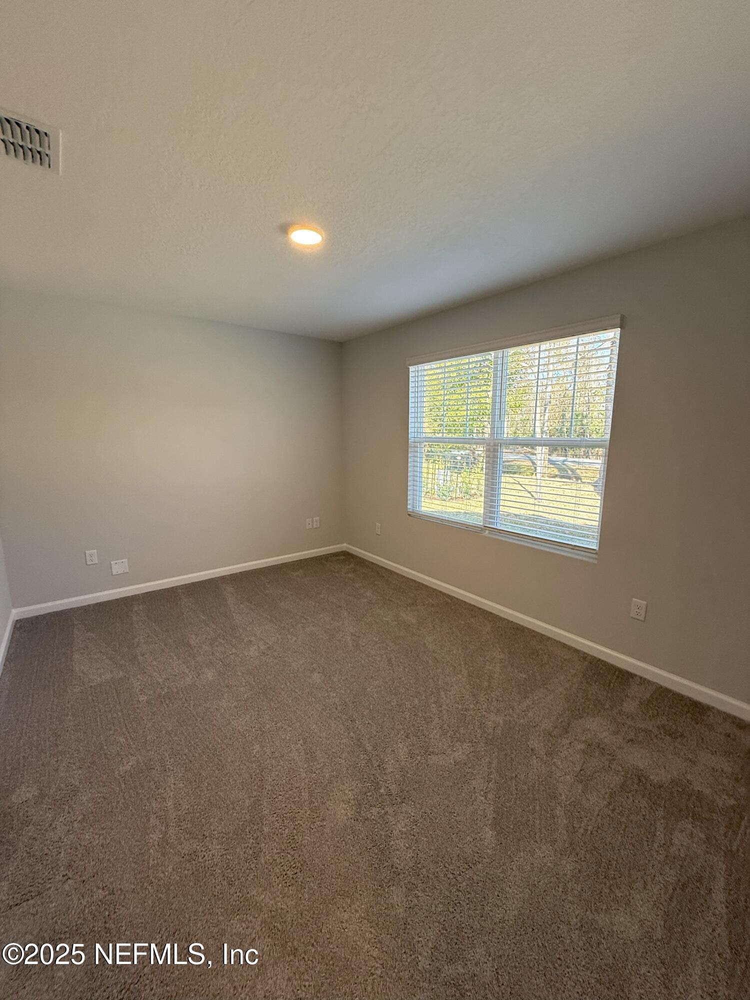 8822 Orme Road Jacksonville, FL 32220 - Photo 24 of 26 an empty room with a window