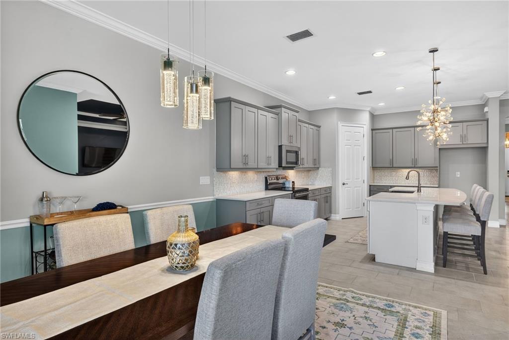 14748 Windward Lane Naples, FL 34114 - Photo 11 of 50 a living room with a couch a window and kitchen view