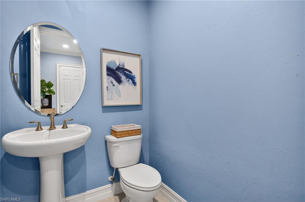 14748 Windward Lane Naples, FL 34114 - Photo 30 of 50 a bathroom with a toilet sink and mirror