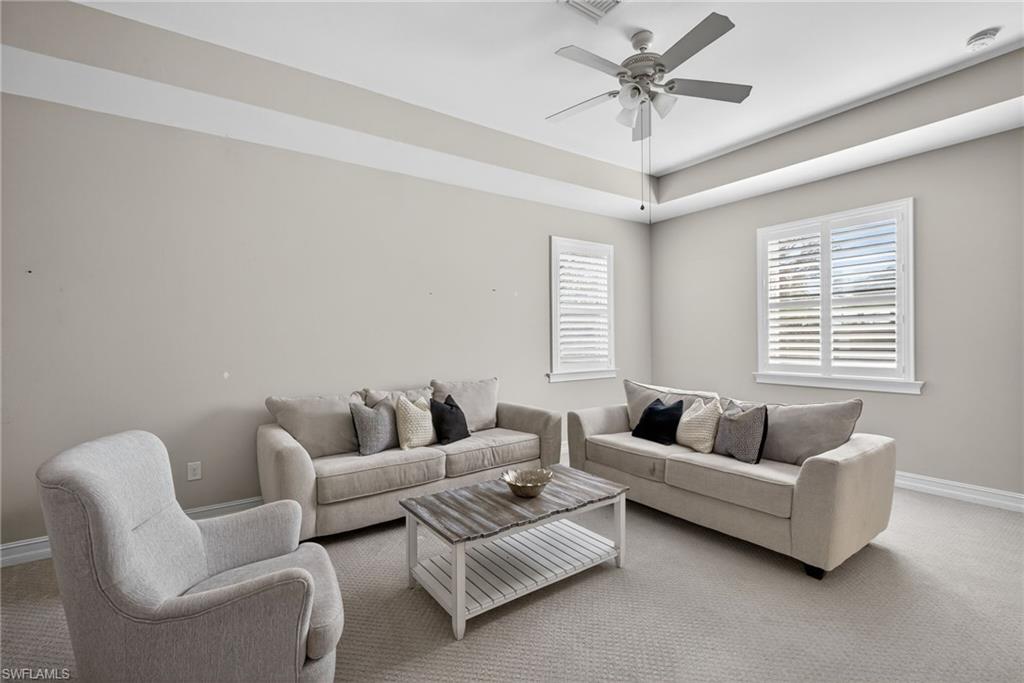 14748 Windward Lane Naples, FL 34114 - Photo 32 of 50 a living room with furniture and a large window