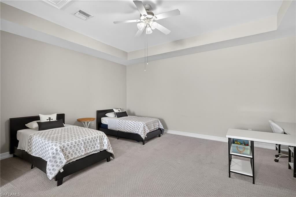 14748 Windward Lane Naples, FL 34114 - Photo 34 of 50 a bedroom with bed and a chandelier