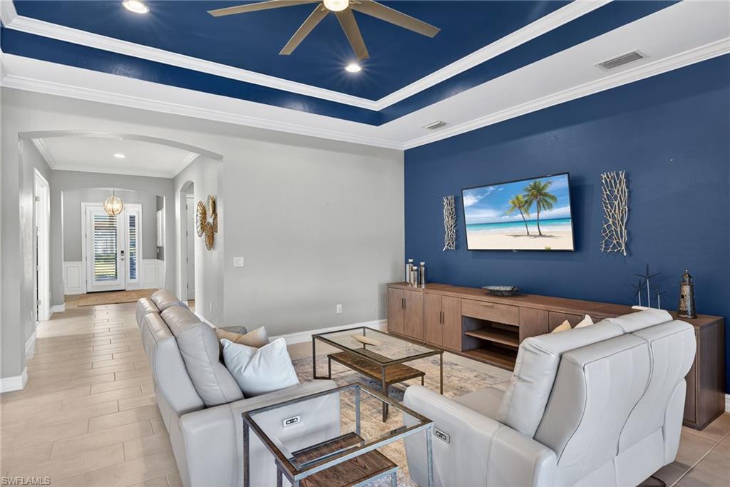 14748 Windward Lane Naples, FL 34114 - Photo 6 of 50 a living room with furniture and a chandelier