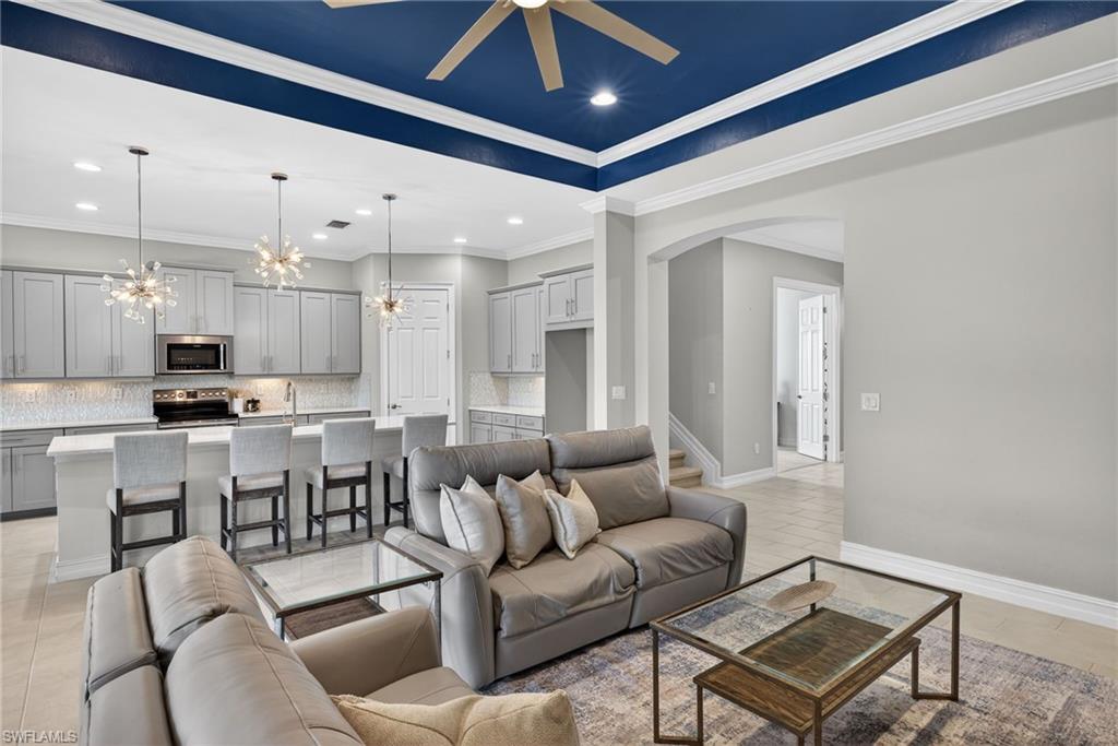 14748 Windward Lane Naples, FL 34114 - Photo 8 of 50 a living room with lots of furniture and kitchen view