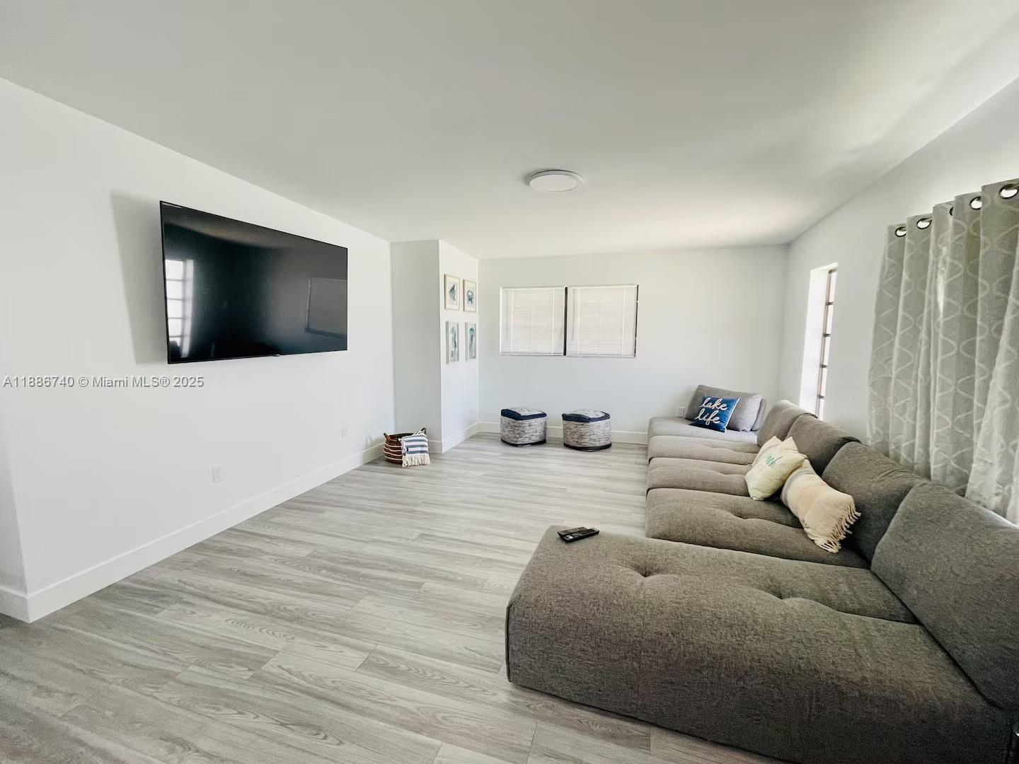 237 2nd Road Key Largo, FL 33037 - Photo 2 of 11 a living room with furniture and a flat screen tv