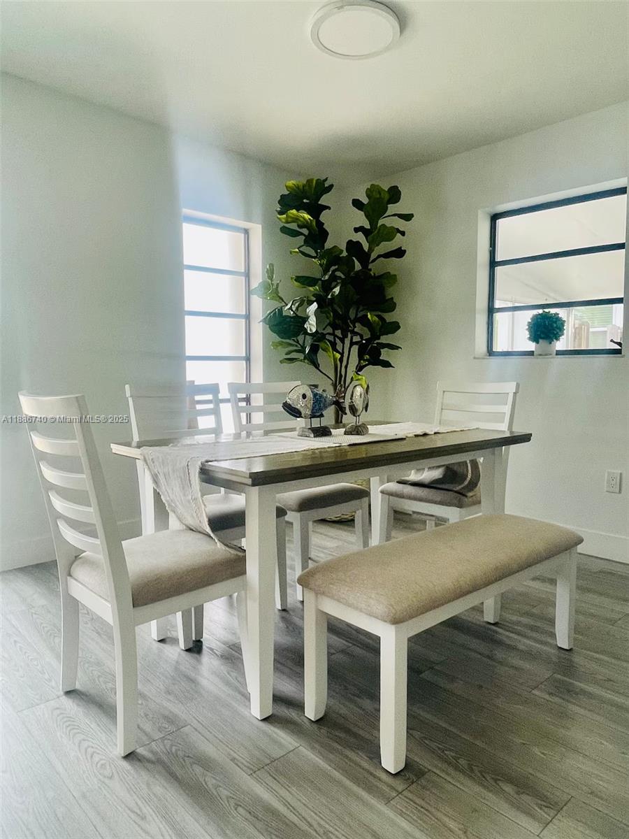 237 2nd Road Key Largo, FL 33037 - Photo 6 of 11 a view of a dining room with furniture and wooden floor