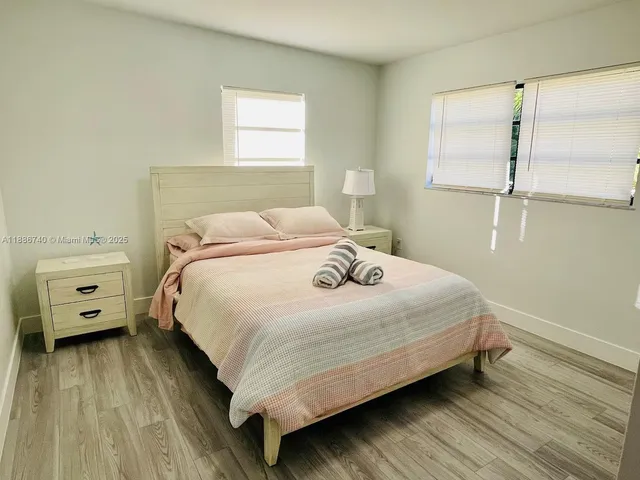 a bedroom with a bed and a tv