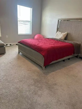 a bedroom with a bed and window