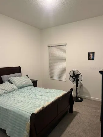 a bedroom with a bed and a table