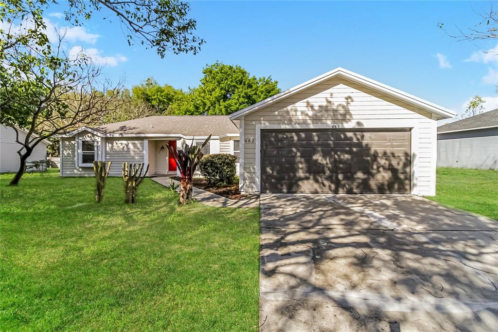 662 Mosquero Avenue Deltona, FL 32738 - Photo 1 of 1 a view of a house with yard and a garden