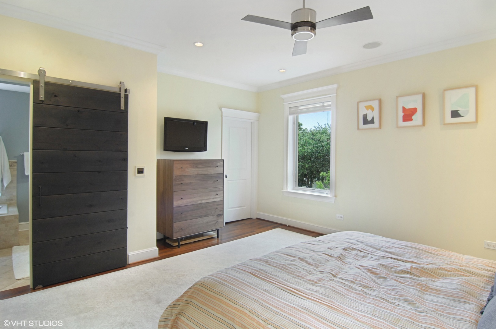 Undisclosed Address Chicago, IL 60618 - Photo 17 of 31 a bedroom with a bed and a flat tv screen on dresser