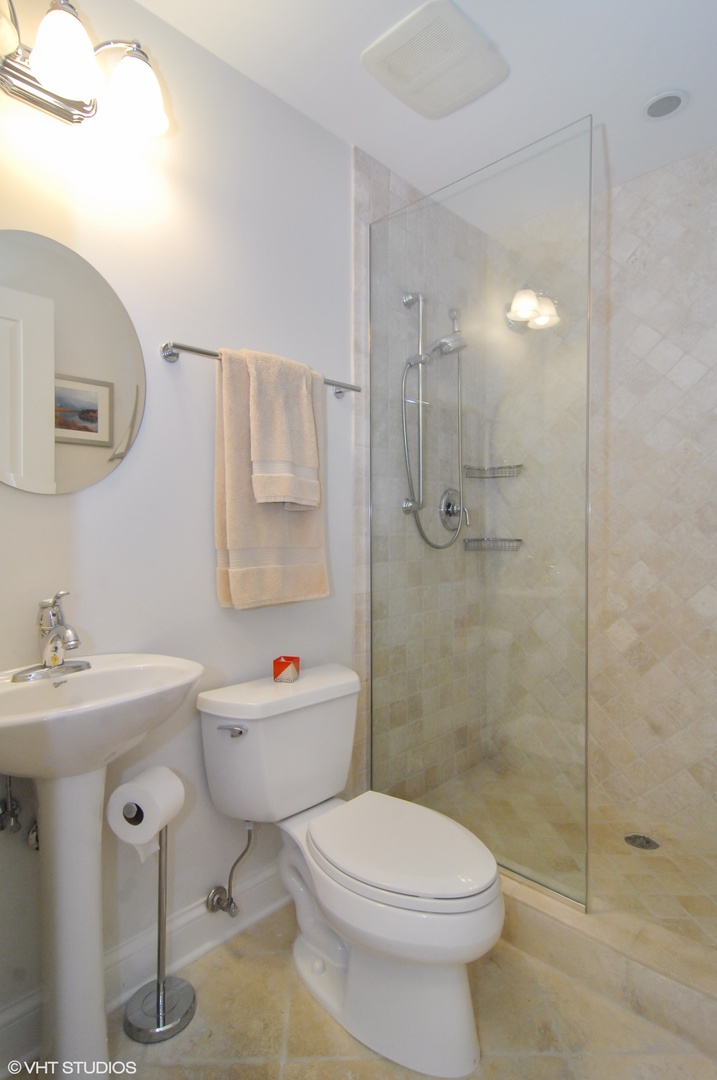 Undisclosed Address Chicago, IL 60618 - Photo 25 of 31 a bathroom with a sink toilet and shower