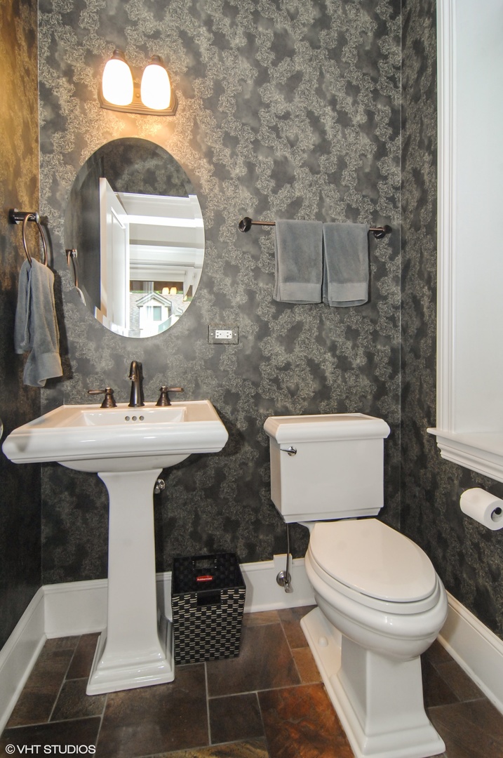 Undisclosed Address Chicago, IL 60618 - Photo 27 of 31 a bathroom with a toilet sink and mirror