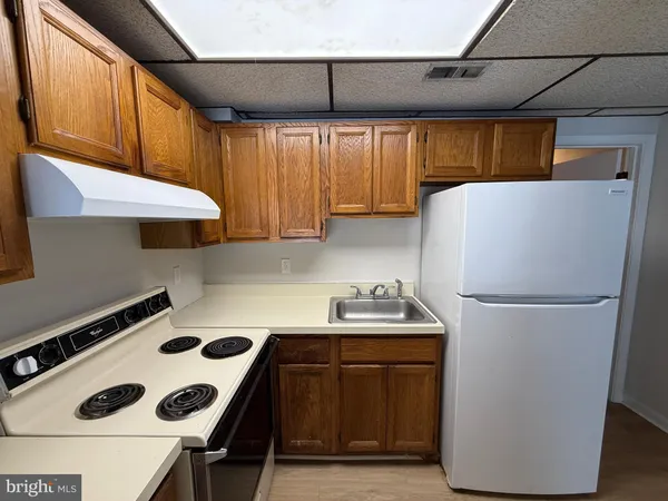 a white refrigerator freezer sitting inside of a kitchen