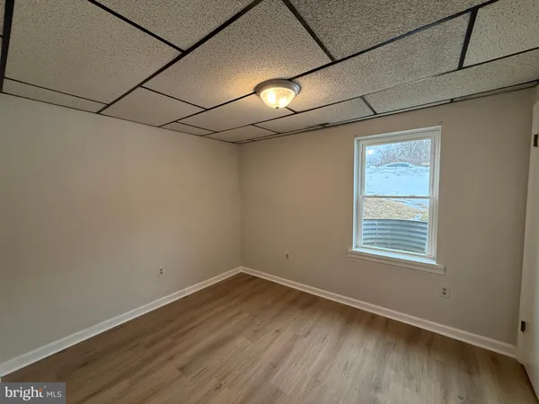 a view of a room with wooden floor and windows