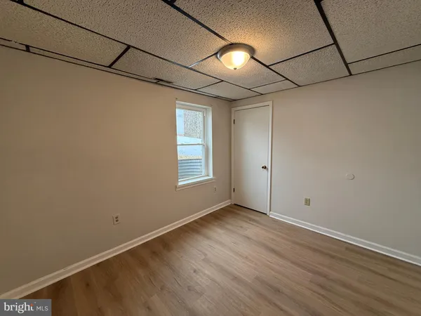a view of a room with wooden floor and window