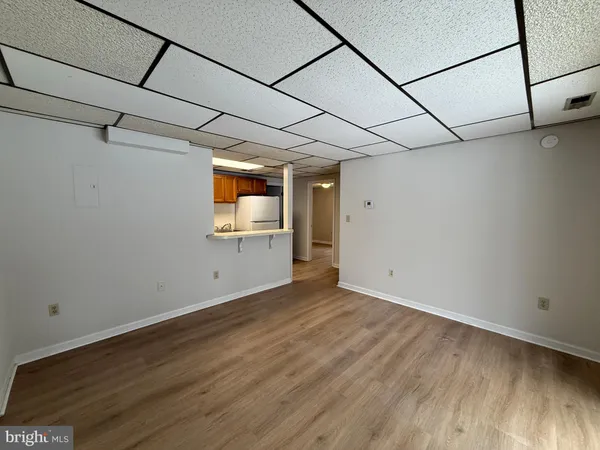 a view of a room with wooden floor and cabinet