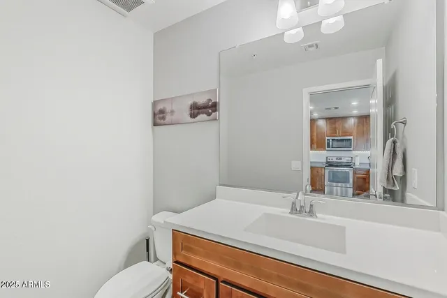 a bathroom with a sink a toilet and mirror