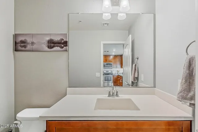 a bathroom with a sink a toilet and a mirror