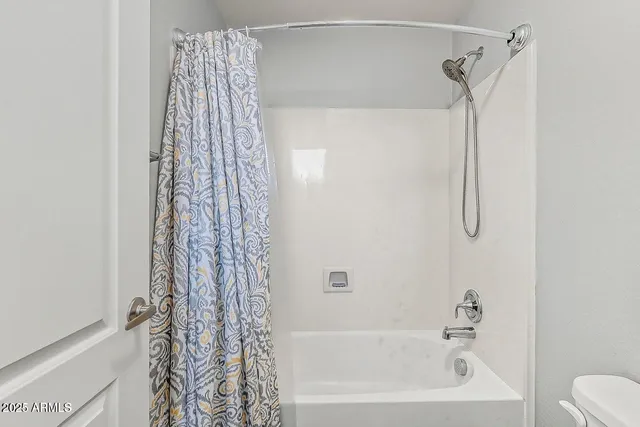 a view of storage and utility room with washer and dryer