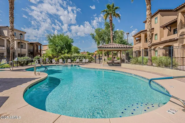 a view of a swimming pool with a yard