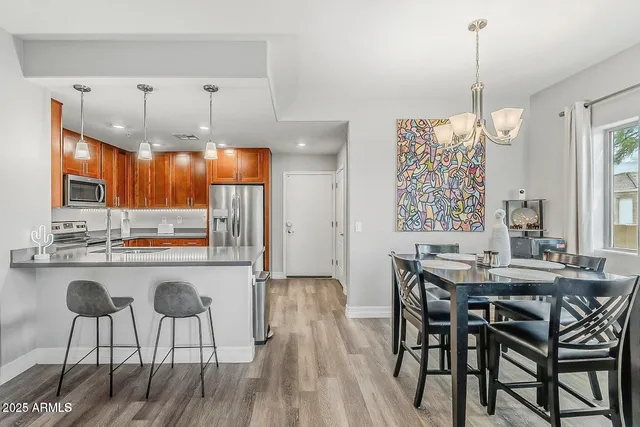 a dining table chairs and chandelier