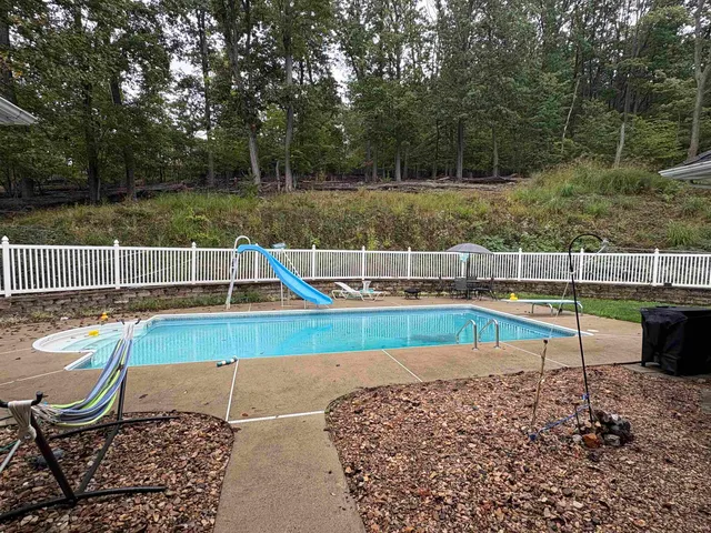 a view of a backyard with wooden fence