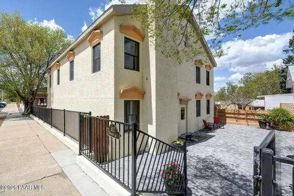 a view of a house with wooden fence