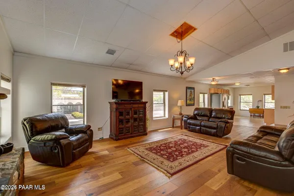 a kitchen with cabinets and chairs