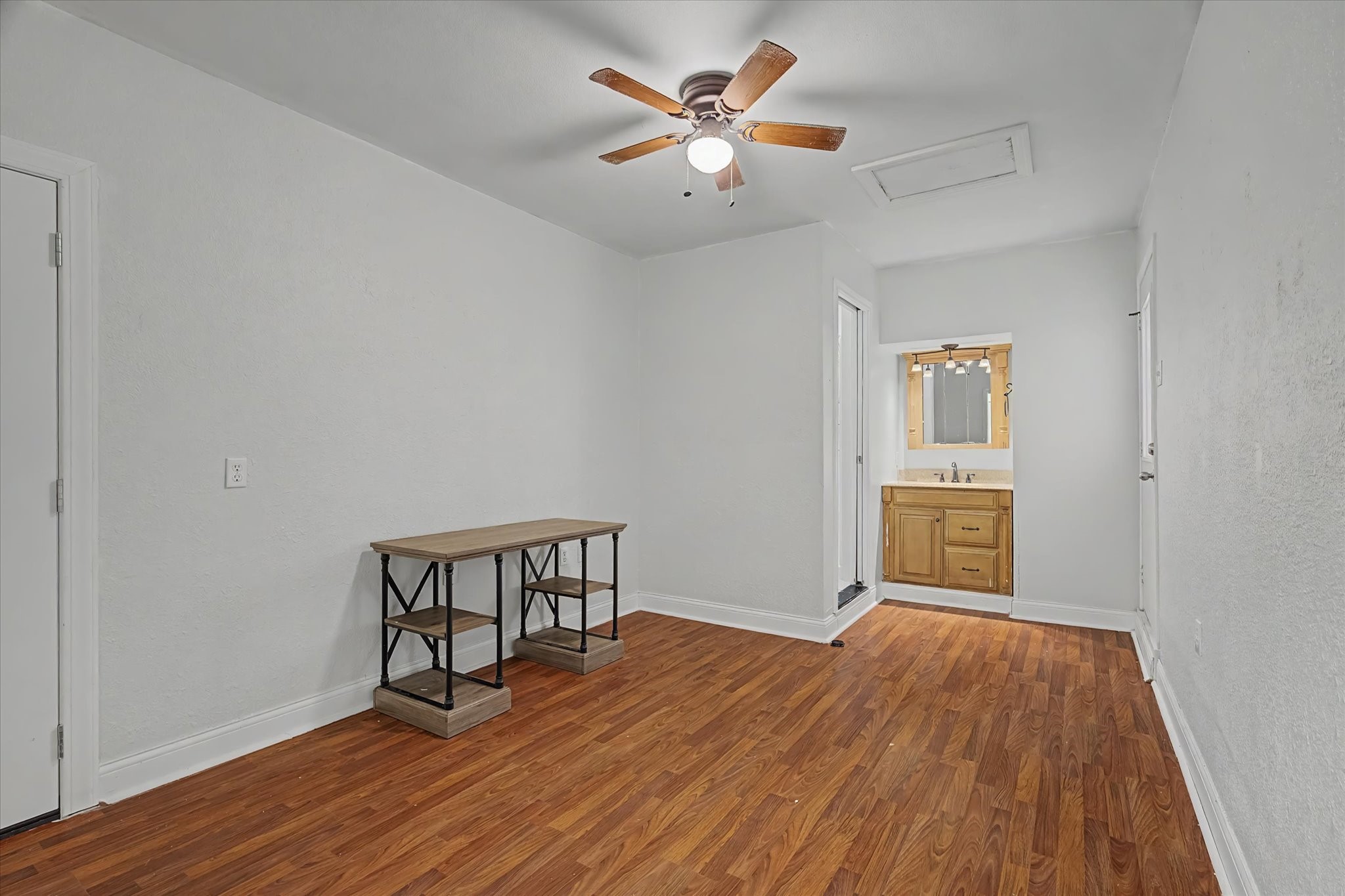 413 Farrer Street Angleton, TX 77515 - Photo 22 of 43 a view of an empty room with a window and wooden floor