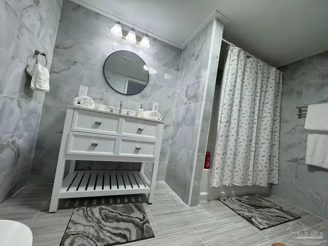 a bathroom with a sink mirror and vanity