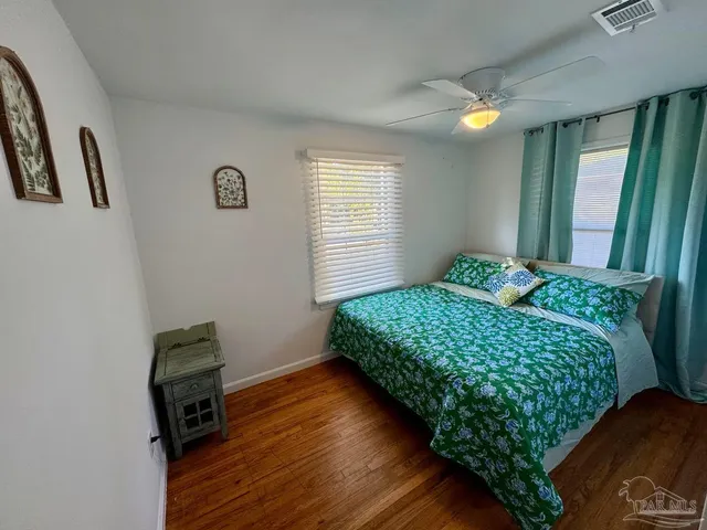 a bedroom with bed and a window