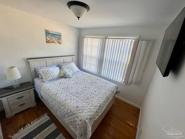 a bed sitting in a bedroom next to a window