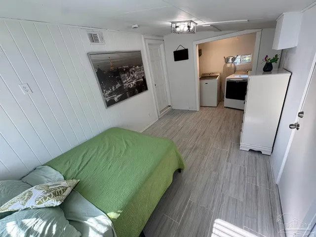 a bedroom with a bed and a couch