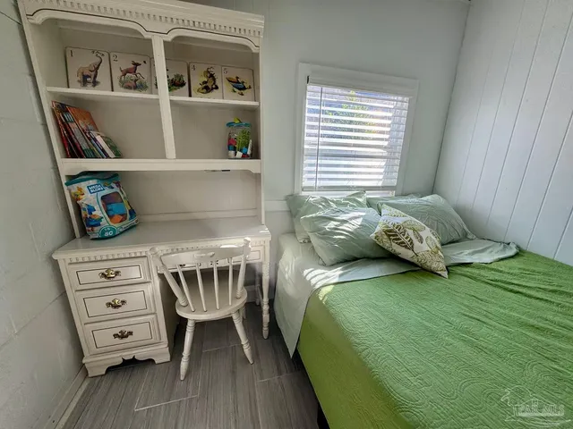 a bedroom with a bed and a book shelf
