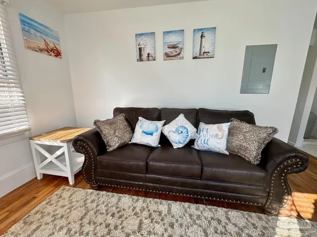 a living room with a couch and a rug