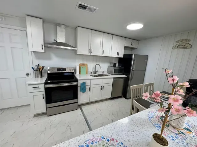 a kitchen with a sink appliances and cabinets