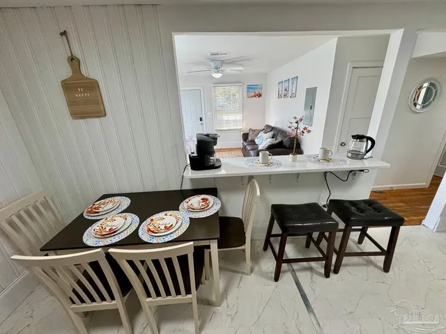 a view of a dining room and kitchen island with furniture
