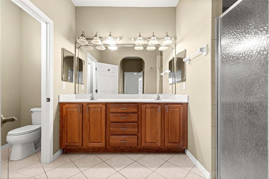 8536 Southwest 82nd Terrace Ocala, FL 34481 - Photo 16 of 47 a spacious bathroom with a double vanity sink mirror and toilet