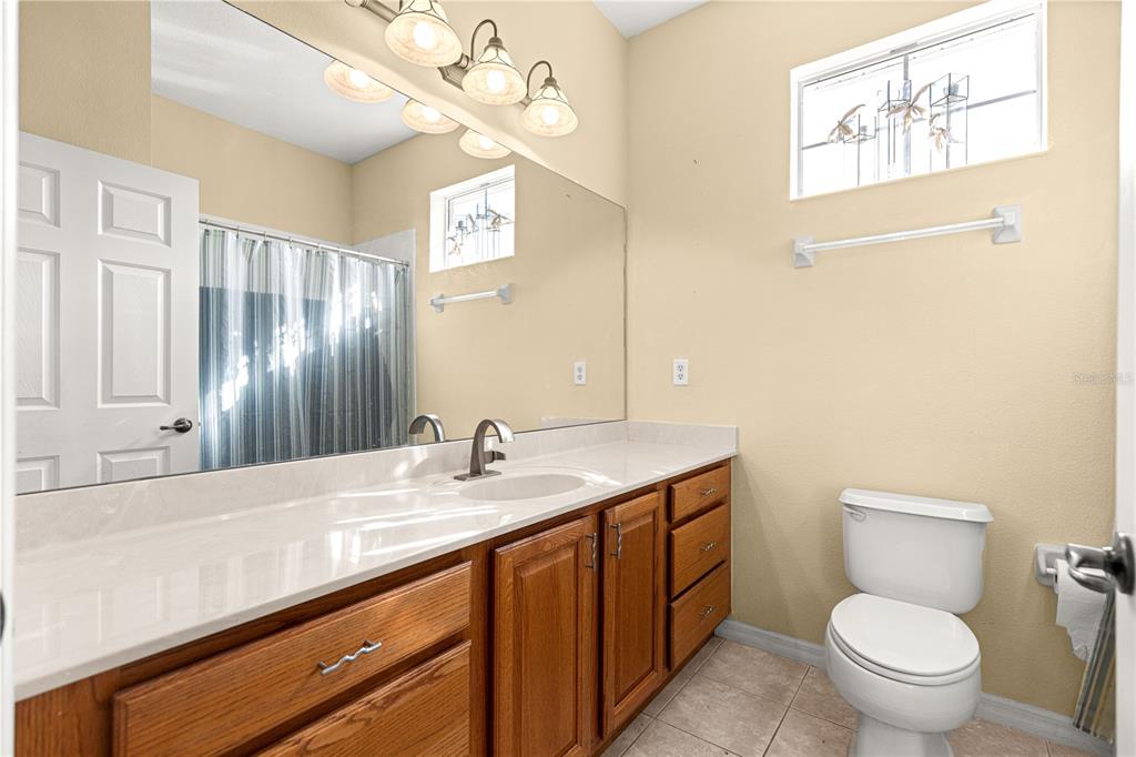 8536 Southwest 82nd Terrace Ocala, FL 34481 - Photo 20 of 47 a bathroom with a granite countertop toilet sink and mirror