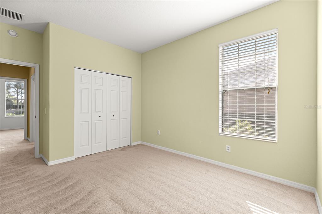 8536 Southwest 82nd Terrace Ocala, FL 34481 - Photo 22 of 47 a view of an empty room with wooden floor and a window
