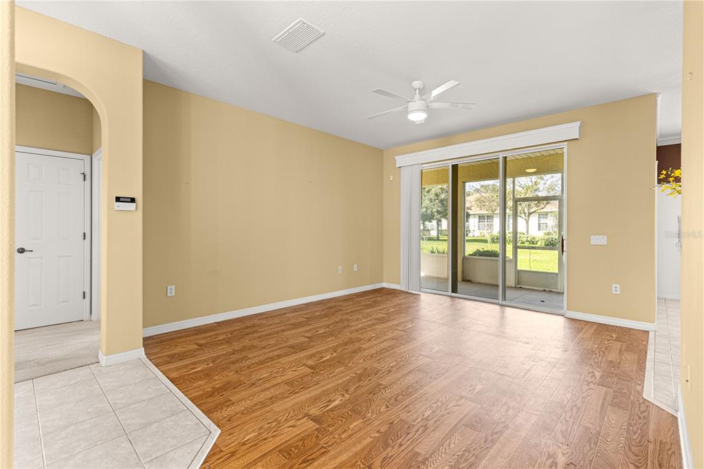 8536 Southwest 82nd Terrace Ocala, FL 34481 - Photo 5 of 47 an empty room with wooden floor and windows