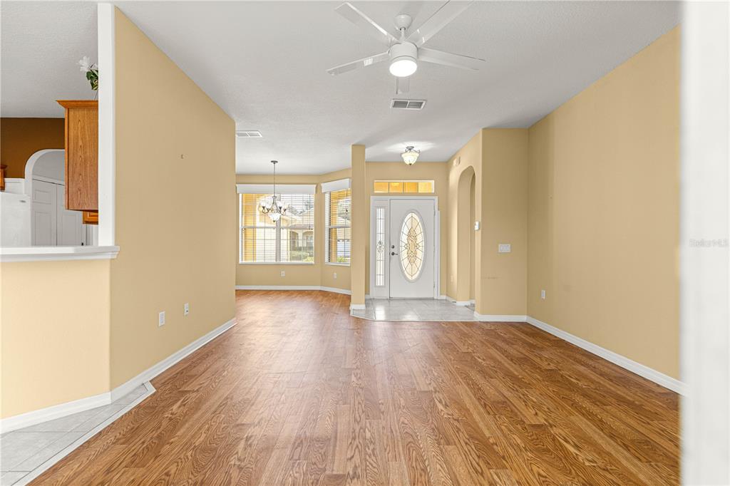 8536 Southwest 82nd Terrace Ocala, FL 34481 - Photo 7 of 47 a view of an empty room with a window and wooden floor