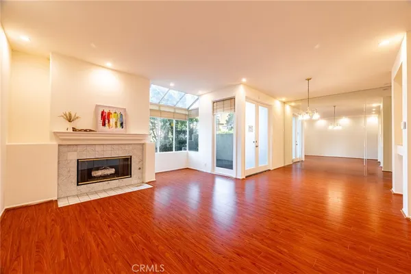 a view of livingroom with fireplace wooden floor and window