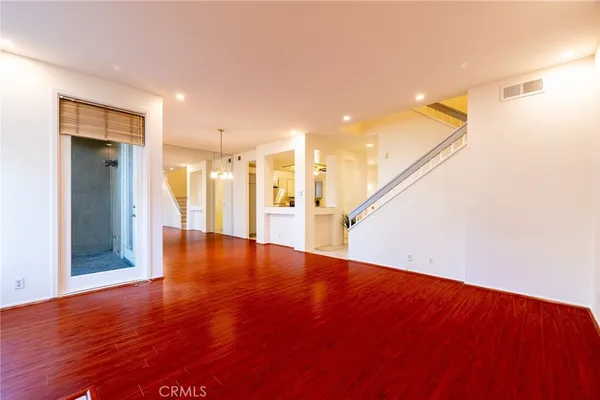 a view of empty room with wooden floor and fireplace