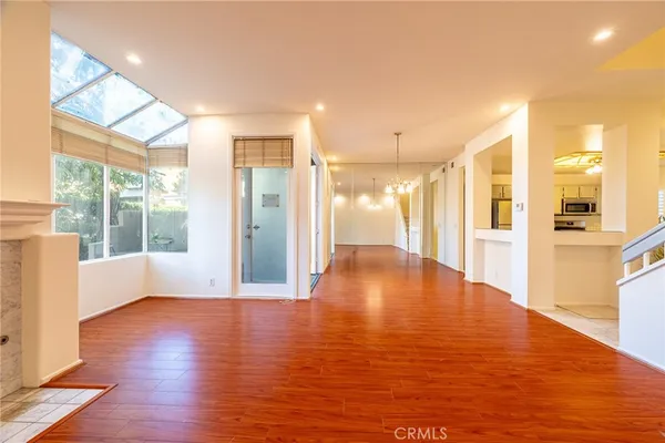 a view of empty room with wooden floor and fireplace